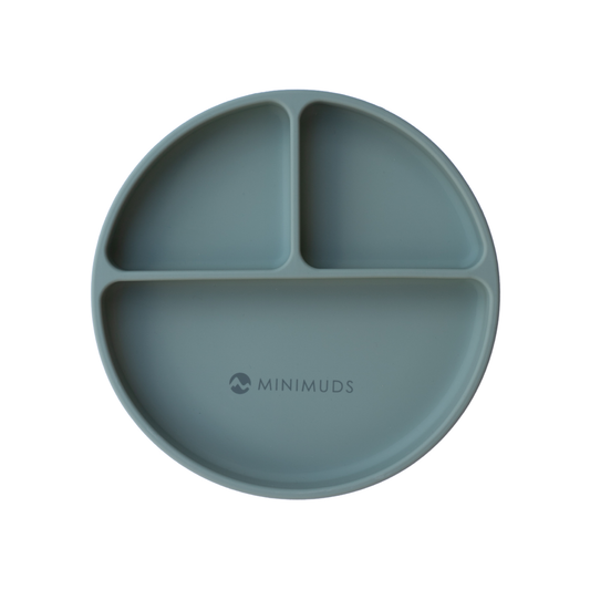 Sage green silicone plate with divided sections on a white background, branded 'MINIMUDS'.