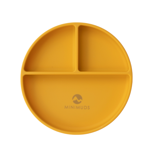 Yellow silicone plate with sections on a white background