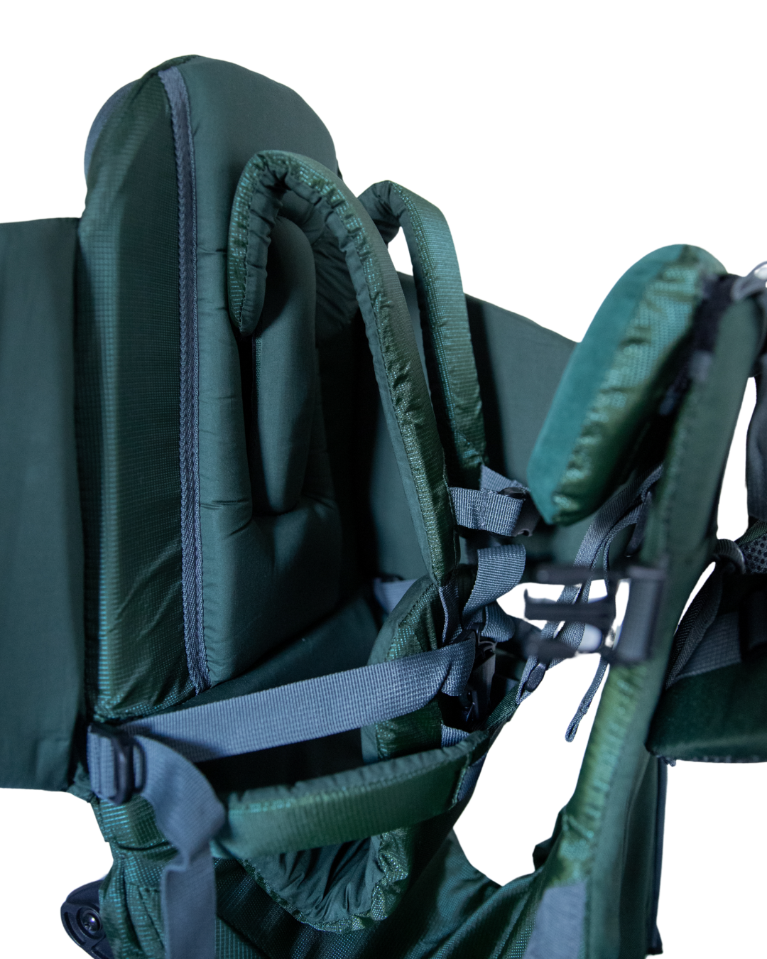 Close-up of a green baby carrier with straps on a white background